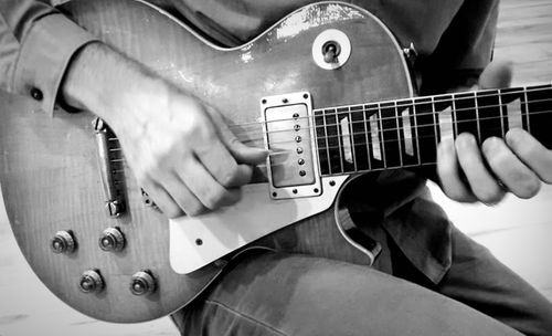 Black and white photo of Vintage Gibson Les Paul being played